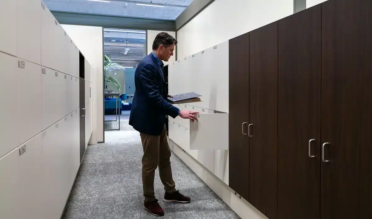 Workplace (industry) Employee accessing a locker in a modern office environment