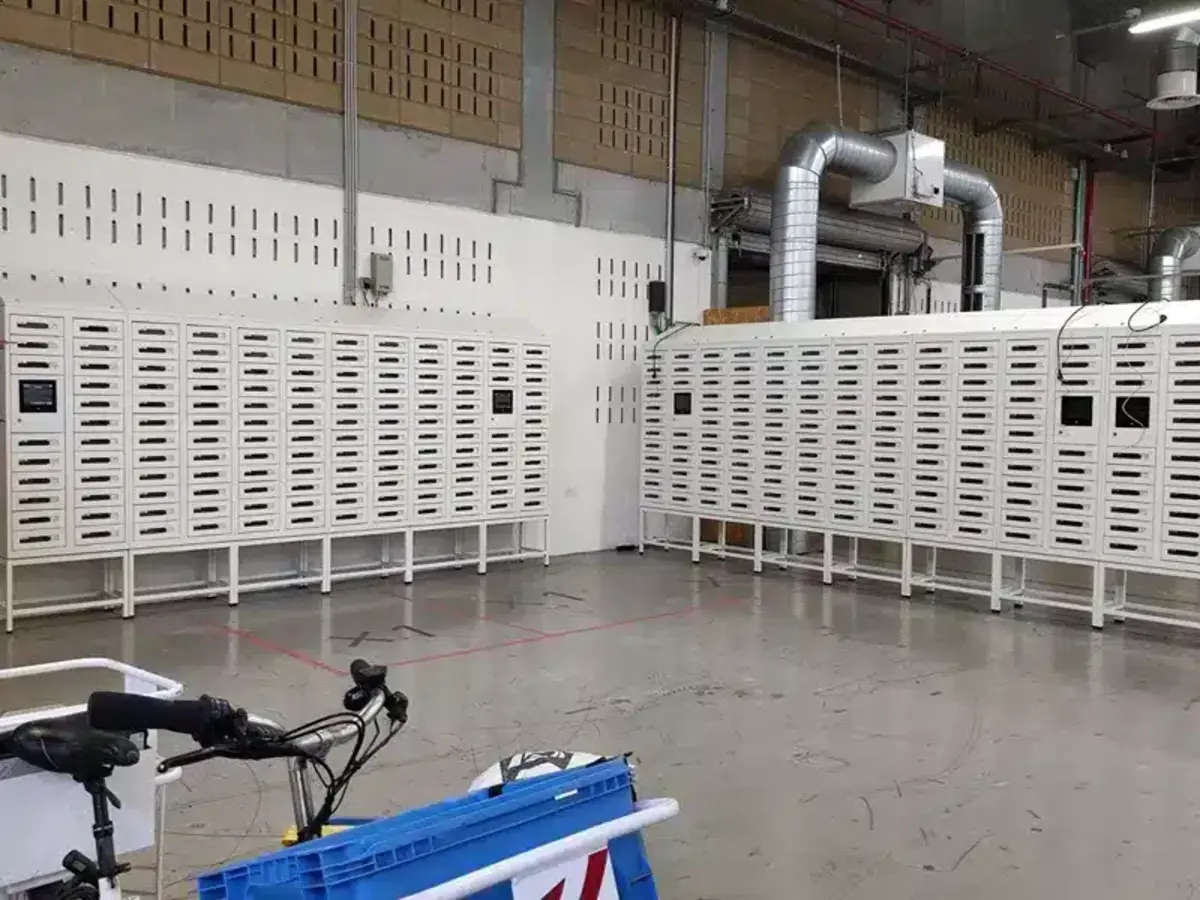 Courier depositing a parcel into a Vpod smart delivery locker