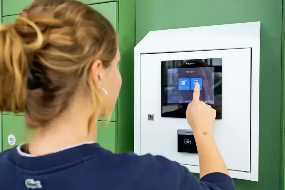 A user accessing a Vpod smart locker touchscreen