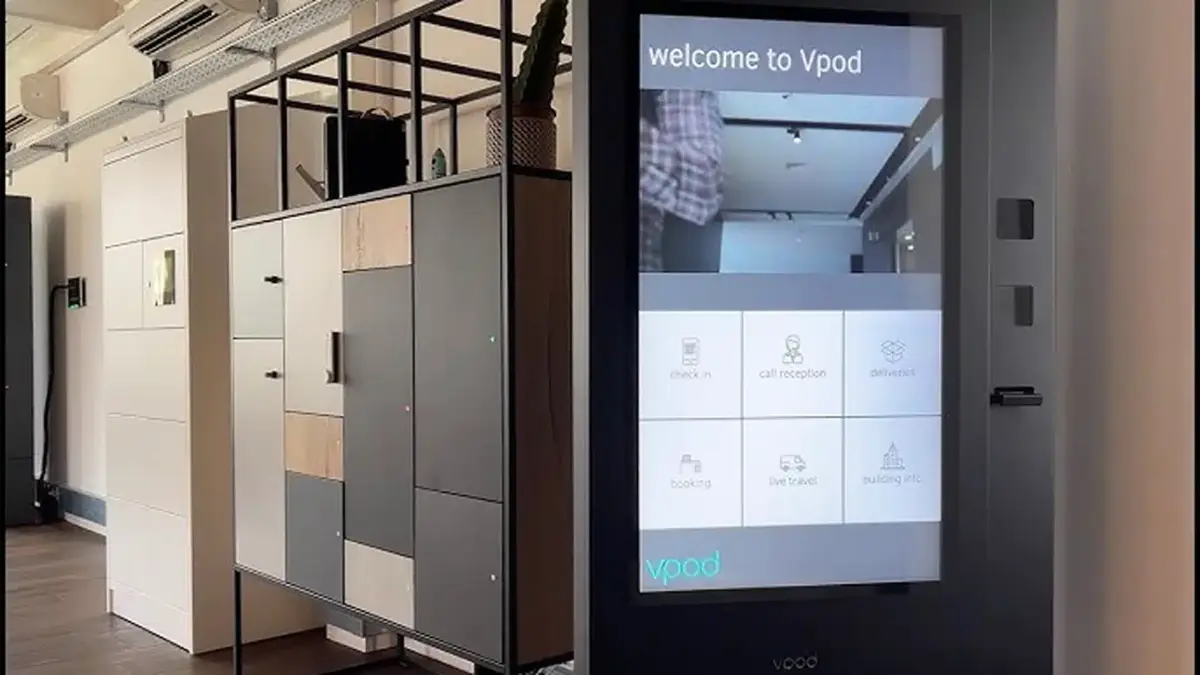 Vpod vGreet reception kiosk beside integrated smart lockers
